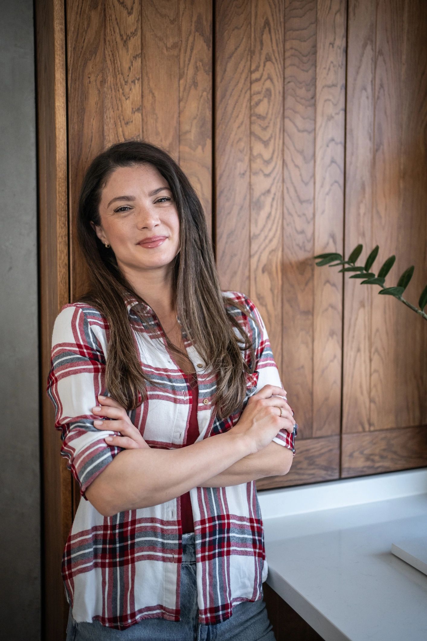 Professional portrait of a confident interior designer in a modern kitchen